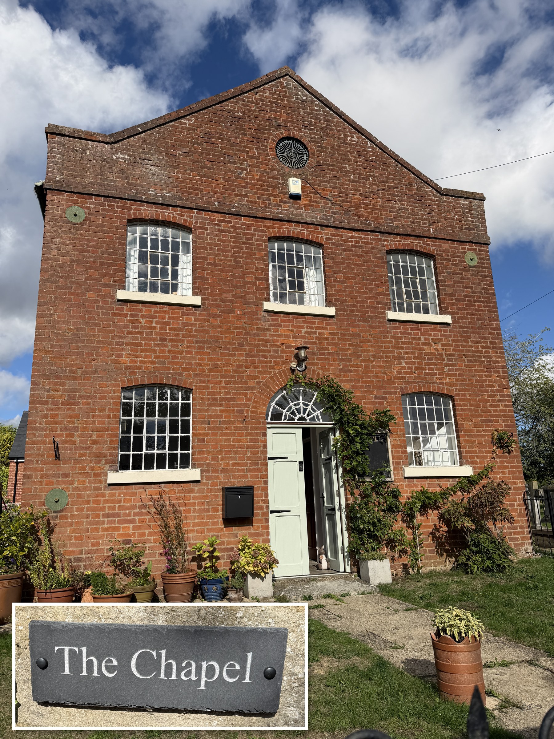 A two-storey red brick building with a gabled roof, large multi-paned windows and a pale green front door, with potted plants and a lawn in front, and an inset photograph of a slate sign reading The Chapel on a brick and stone gatepost.
